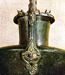 Detail of lower handle attachment with stylized human features.