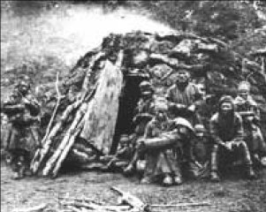 Old picture of Sami in front of traditional Sami dwelling