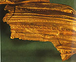 detail with stamped horsemen and large tear through gol